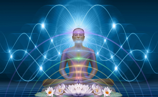 a person sitting in meditation with energy waves emanating